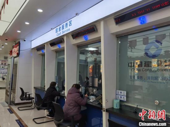 圖為蘭州市民在銀行兌換新鈔。 徐雪 攝 圖為蘭州市民在銀行兌換新鈔。 徐雪 攝